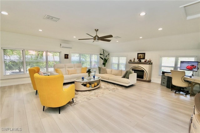 2061 Santa Barbara Blvd, Naples, FL 34116 - living room featuring a glass covered fireplace, light wood-type flooring, a wall unit AC, a ceiling fan, and an office area