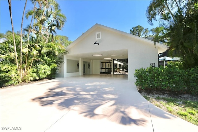 2061 Santa Barbara Blvd, Naples, FL 34116 - view of front of house featuring driveway, stucco siding, and a carport