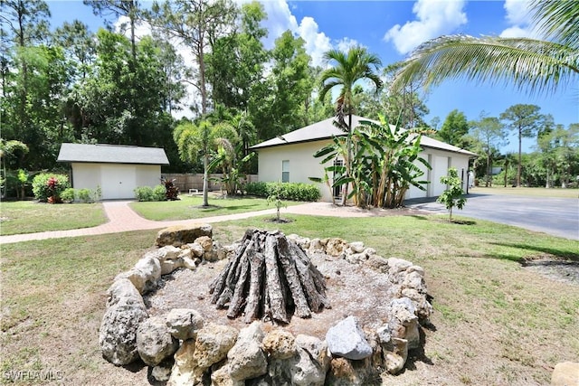 2061 Santa Barbara Blvd, Naples, FL 34116 - view of front of home featuring an outbuilding, stucco siding, and driveway