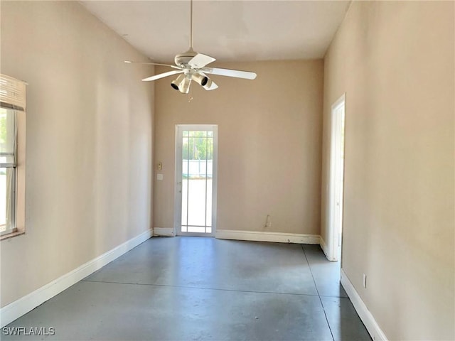 2061 Santa Barbara Blvd, Naples, FL 34116 - empty room with finished concrete flooring, baseboards, and a ceiling fan