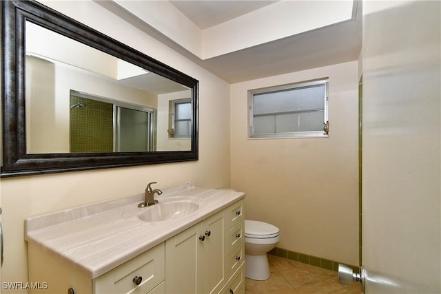 bathroom with vanity, tile patterned flooring, an enclosed shower, and toilet