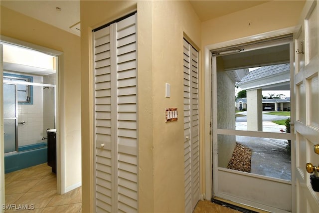 doorway with tile patterned floors