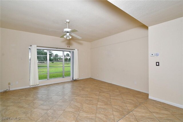empty room featuring baseboards and a ceiling fan