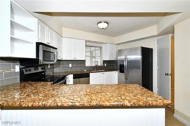 kitchen with open shelves, a sink, backsplash, and appliances with stainless steel finishes