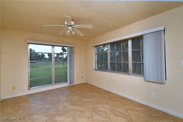 empty room featuring baseboards and a ceiling fan