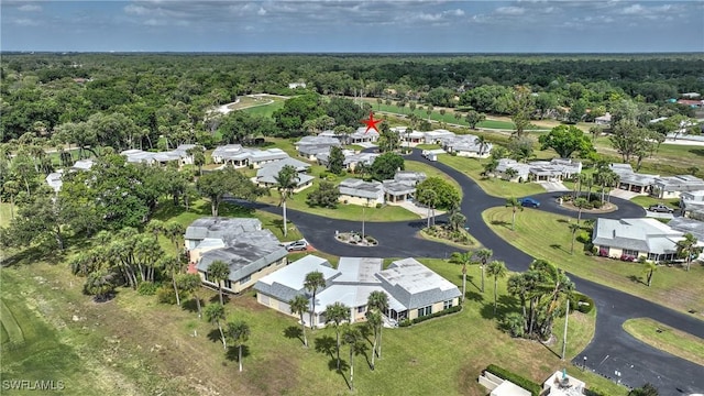 birds eye view of property with a residential view and a wooded view