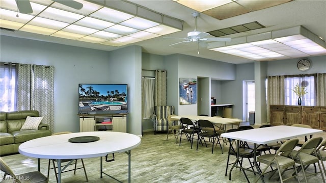 dining area with light wood-type flooring, a ceiling fan, and baseboards