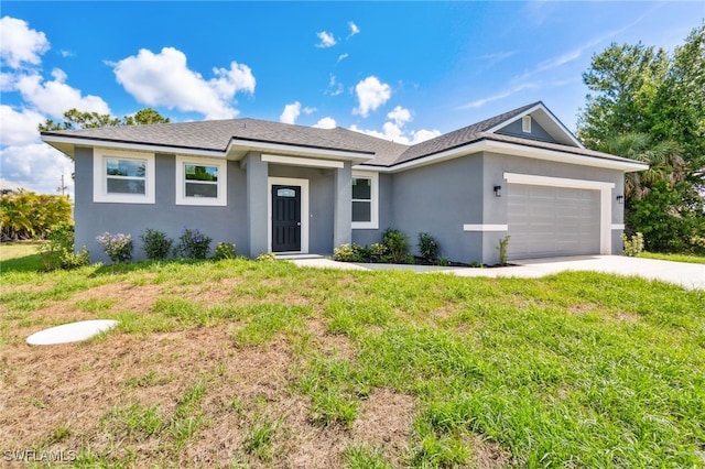 8 Cleat Ct, Placida, FL 33946 - view of front of property with stucco siding, a front lawn, a garage, and driveway