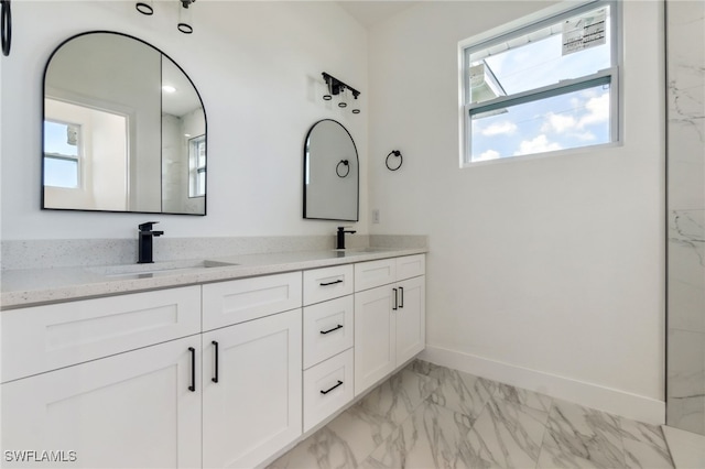 8 Cleat Ct, Placida, FL 33946 - bathroom featuring marble finish floors, baseboards, double vanity, and plenty of natural light