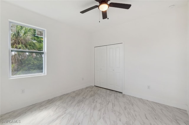 8 Cleat Ct, Placida, FL 33946 - unfurnished bedroom with baseboards, a closet, and a ceiling fan