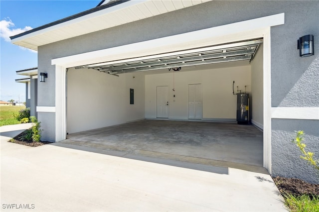 8 Cleat Ct, Placida, FL 33946 - garage with electric water heater, concrete driveway, electric panel, and a garage door opener
