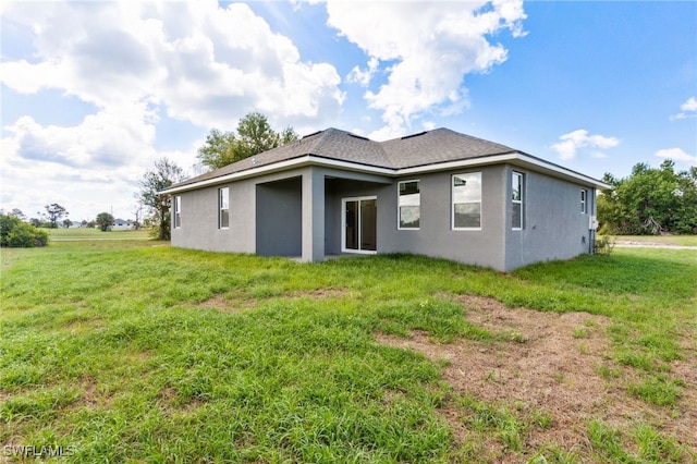 8 Cleat Ct, Placida, FL 33946 - rear view of house featuring stucco siding and a yard