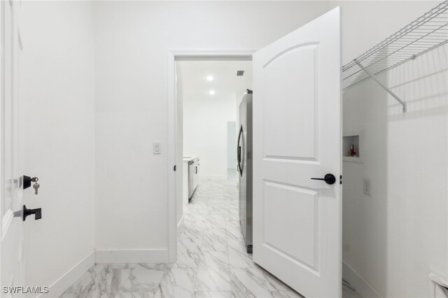 8 Cleat Ct, Placida, FL 33946 - laundry room with light marble finish flooring, baseboards, and hookup for a washing machine