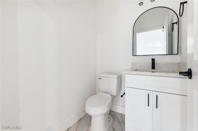 8 Cleat Ct, Placida, FL 33946 - half bath with baseboards, marble finish floors, toilet, and vanity