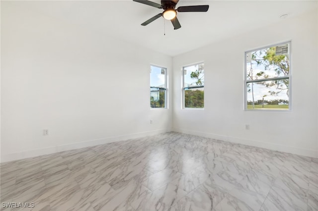 8 Cleat Ct, Placida, FL 33946 - spare room with ceiling fan, marble look tiles, and baseboards