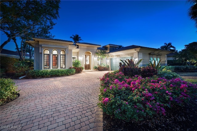 1716 Venezia Way, Naples, FL 34105 - mediterranean / spanish-style home with an attached garage, stucco siding, and decorative driveway