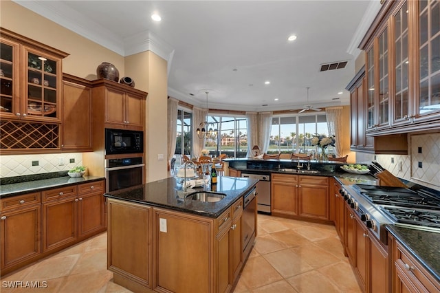 1716 Venezia Way, Naples, FL 34105 - kitchen featuring appliances with stainless steel finishes, brown cabinets, dark stone countertops, decorative backsplash, and recessed lighting