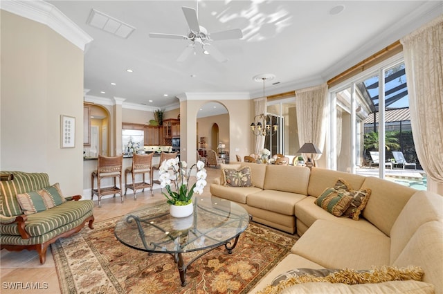 1716 Venezia Way, Naples, FL 34105 - living area featuring ornamental molding, a ceiling fan, a chandelier, arched walkways, and light tile patterned flooring