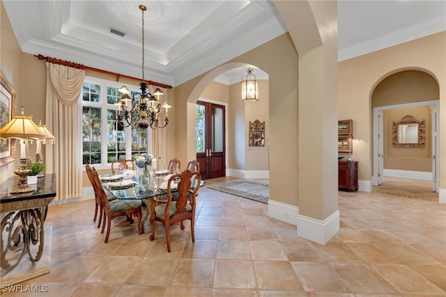 1716 Venezia Way, Naples, FL 34105 - dining space featuring a chandelier, arched walkways, and ornamental molding