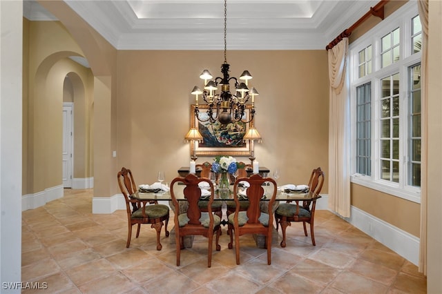 1716 Venezia Way, Naples, FL 34105 - dining area with arched walkways, a chandelier, crown molding, a tray ceiling, and light tile patterned flooring