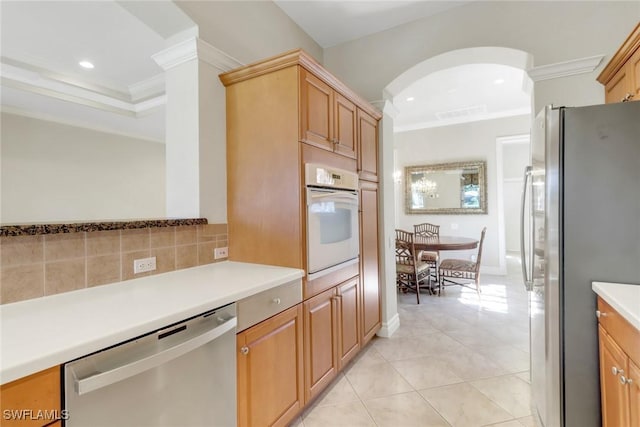14070 Tivoli Ter, Bonita Springs, FL 34135 - kitchen with crown molding, light tile patterned flooring, recessed lighting, light countertops, and appliances with stainless steel finishes