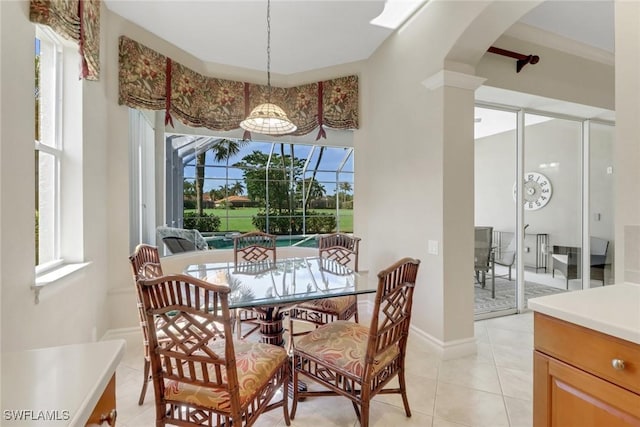 14070 Tivoli Ter, Bonita Springs, FL 34135 - dining room with arched walkways, light tile patterned flooring, and a wealth of natural light