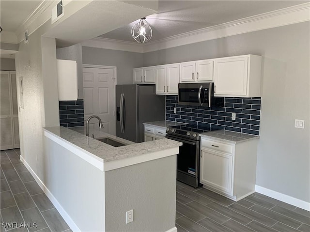 kitchen featuring tasteful backsplash, white cabinetry, crown molding, stainless steel appliances, and a sink