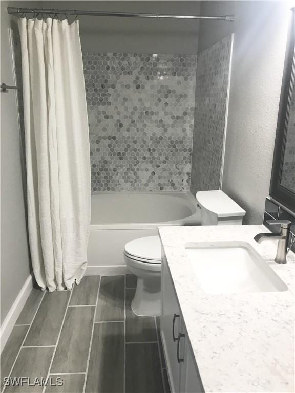 bathroom featuring shower / bathtub combination with curtain, vanity, and toilet