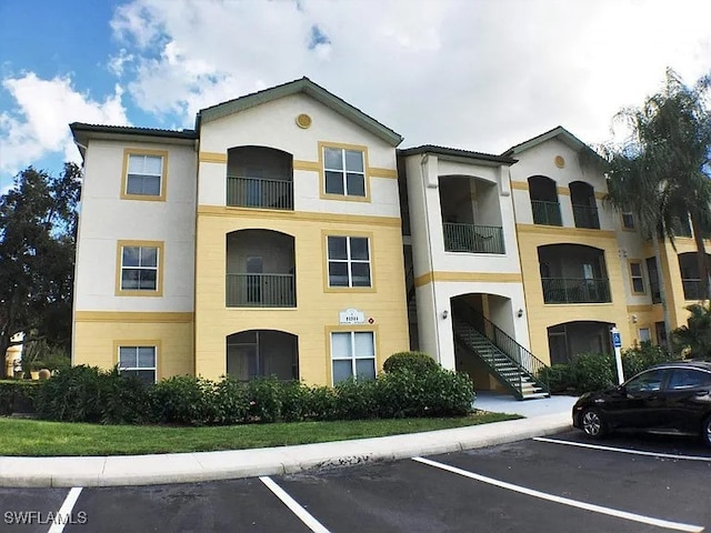 view of building exterior featuring uncovered parking