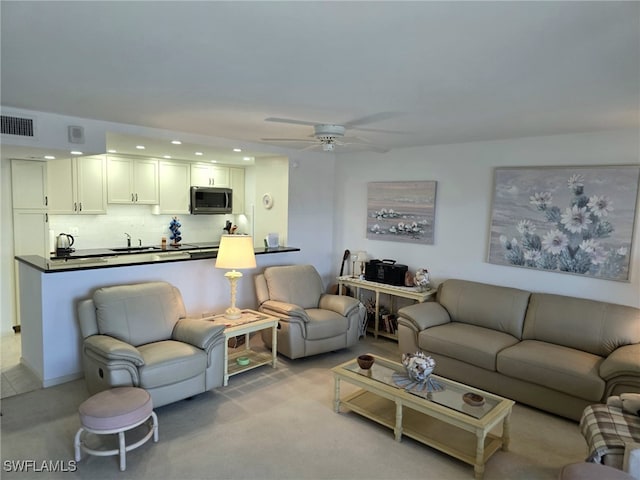 living area with recessed lighting, visible vents, and a ceiling fan