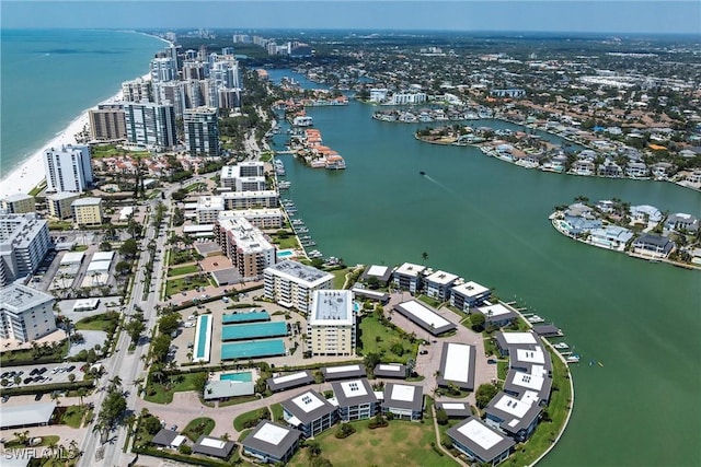 birds eye view of property with a city view and a water view
