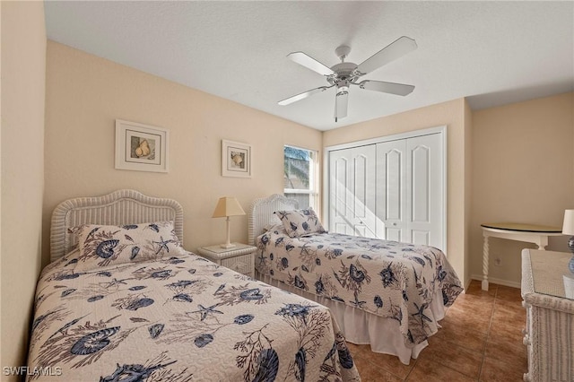 bedroom with a ceiling fan, tile patterned flooring, and a closet