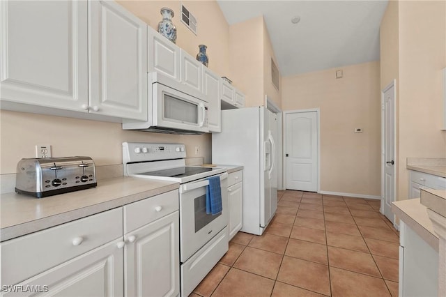 kitchen featuring white appliances, light tile patterned floors, light countertops, white cabinetry, and visible vents