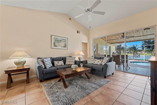 living area with light tile patterned floors, baseboards, visible vents, a ceiling fan, and lofted ceiling