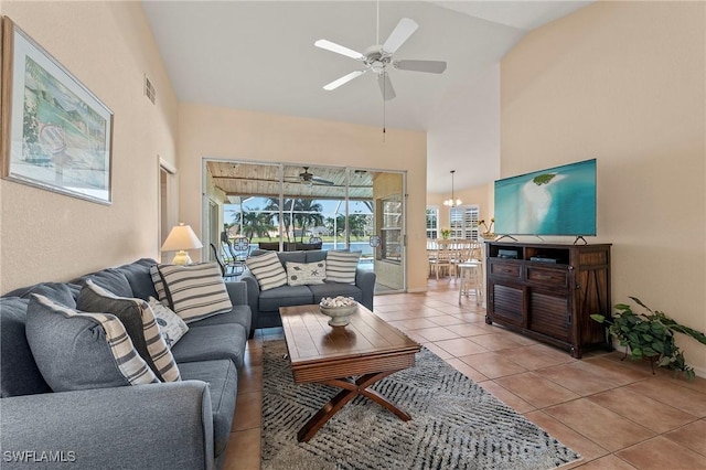 living room with visible vents, light tile patterned floors, ceiling fan, and high vaulted ceiling