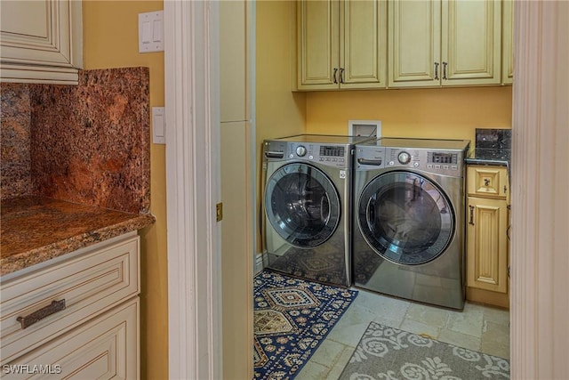 419 Pine Ave, Naples, FL 34108 - washroom with stone finish floor, washing machine and clothes dryer, and cabinet space