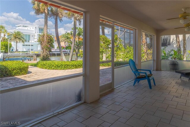 419 Pine Ave, Naples, FL 34108 - unfurnished sunroom featuring a water view and a ceiling fan