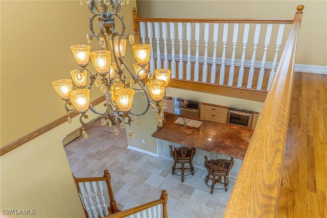 419 Pine Ave, Naples, FL 34108 - interior space with baseboards and an inviting chandelier