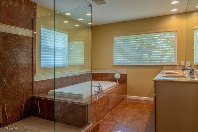 419 Pine Ave, Naples, FL 34108 - bathroom with a bath, a walk in shower, vanity, and recessed lighting
