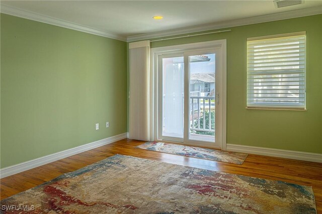 419 Pine Ave, Naples, FL 34108 - entryway featuring crown molding, a wealth of natural light, wood finished floors, and baseboards