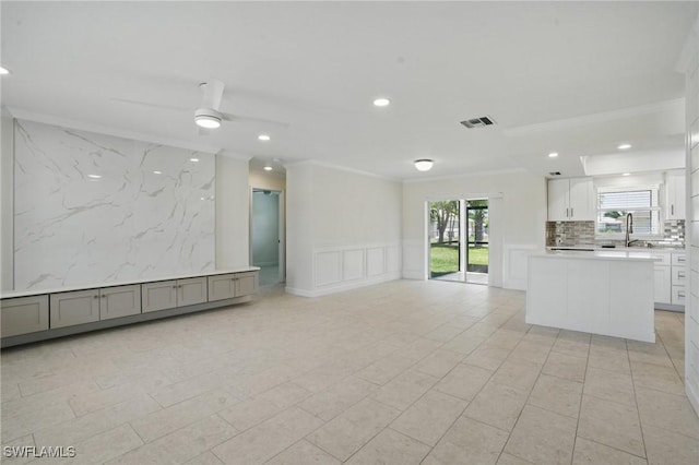 2203 SE Santa Barbara Pl, Cape Coral, FL 33990 - unfurnished living room featuring a wealth of natural light, recessed lighting, and crown molding