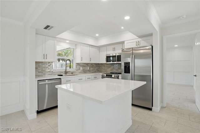 2203 SE Santa Barbara Pl, Cape Coral, FL 33990 - kitchen with ornamental molding, backsplash, visible vents, appliances with stainless steel finishes, and a sink