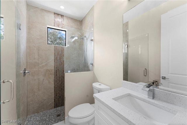 full bath with toilet, a shower stall, and vanity