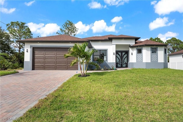 view of front facade featuring an attached garage, stucco siding, a front lawn, and decorative driveway