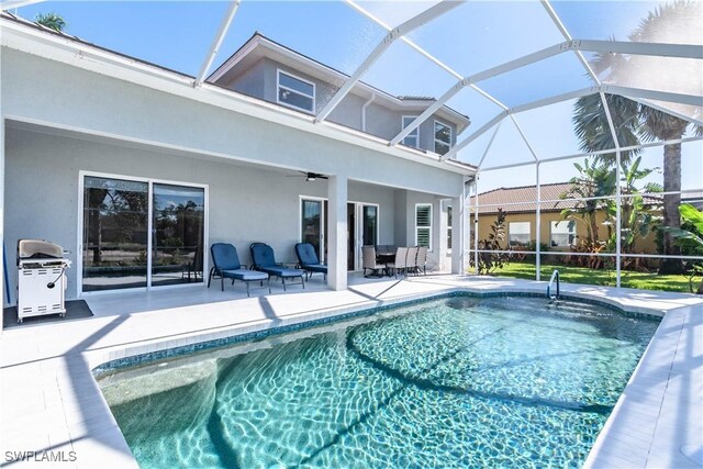 14696 Indigo Lakes Cir, Naples, FL 34119 - pool featuring grilling area, a patio area, a lanai, and ceiling fan