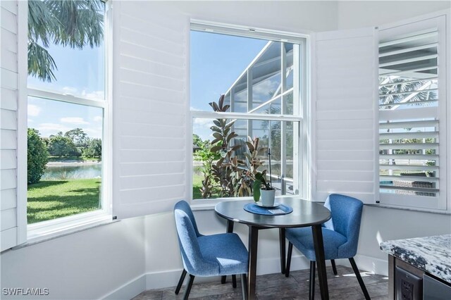 14696 Indigo Lakes Cir, Naples, FL 34119 - dining room featuring a water view and baseboards