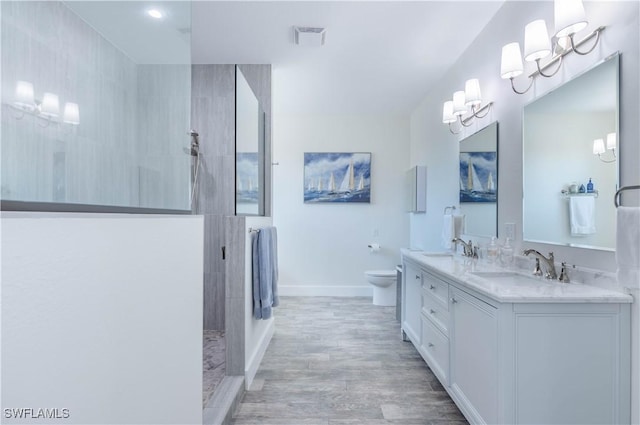 14696 Indigo Lakes Cir, Naples, FL 34119 - bathroom featuring walk in shower, wood finished floors, a sink, and visible vents
