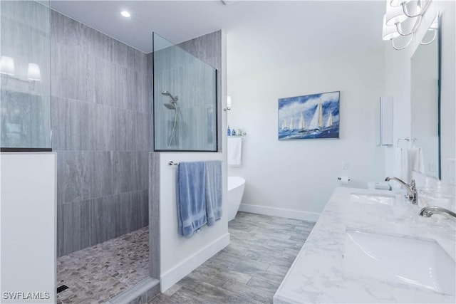 14696 Indigo Lakes Cir, Naples, FL 34119 - full bath with a soaking tub, walk in shower, baseboards, and a sink