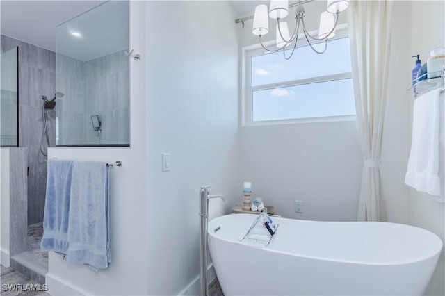14696 Indigo Lakes Cir, Naples, FL 34119 - bathroom with walk in shower, a freestanding tub, and a notable chandelier