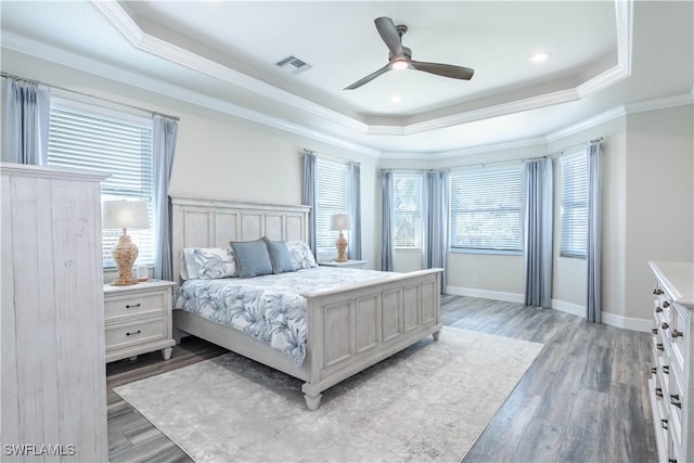 14696 Indigo Lakes Cir, Naples, FL 34119 - bedroom with light wood-type flooring, visible vents, a raised ceiling, and crown molding